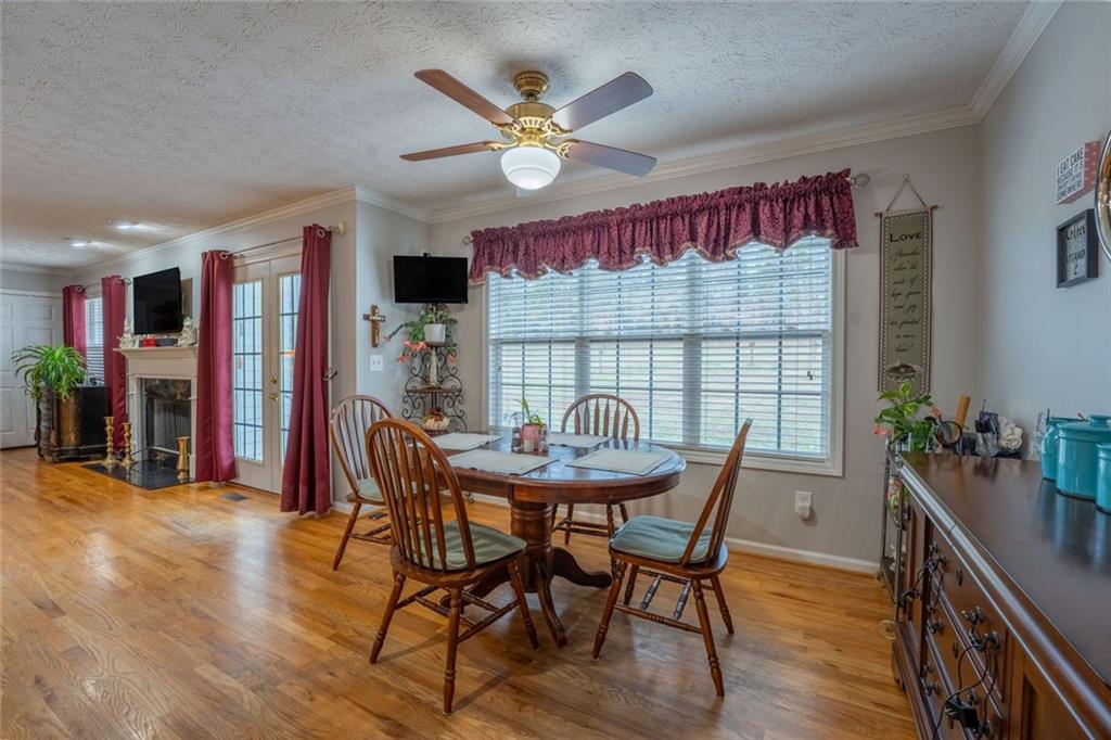 2440 Deadwyler Road Maysville, GA 30558 - Photo 17 of 79 a dining room with furniture window and wooden floor