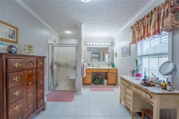 a bedroom with two beds and a chandelier