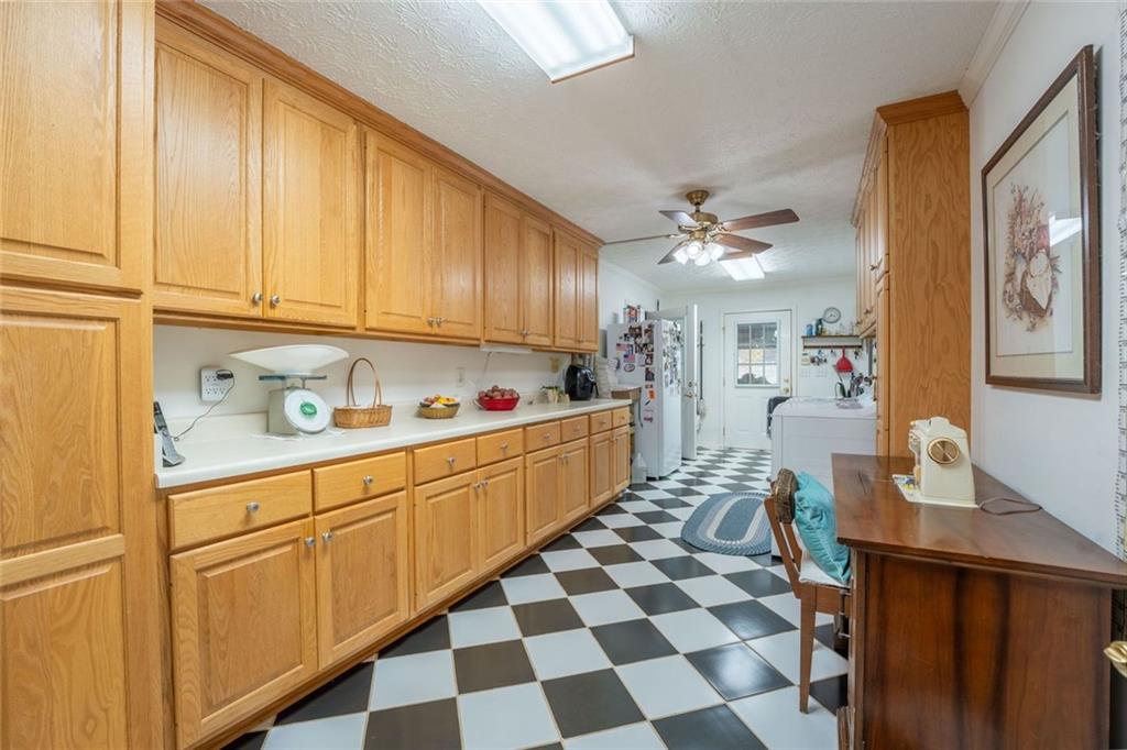 2440 Deadwyler Road Maysville, GA 30558 - Photo 20 of 79 a kitchen with stainless steel appliances granite countertop a sink and cabinets