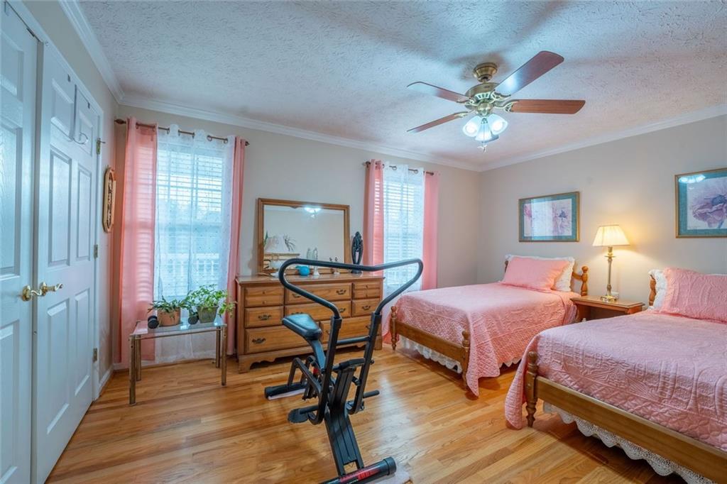 2440 Deadwyler Road Maysville, GA 30558 - Photo 22 of 79 a bedroom with two beds and a chandelier