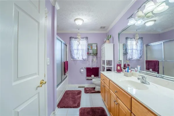 a bathroom with a sink vanity mirror and toilet
