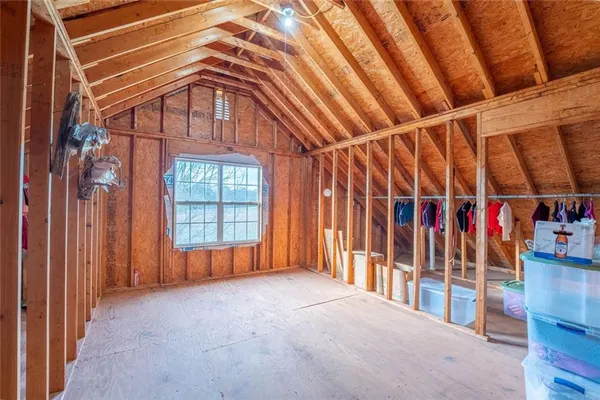 a living room with furniture gym equipment and a chandelier