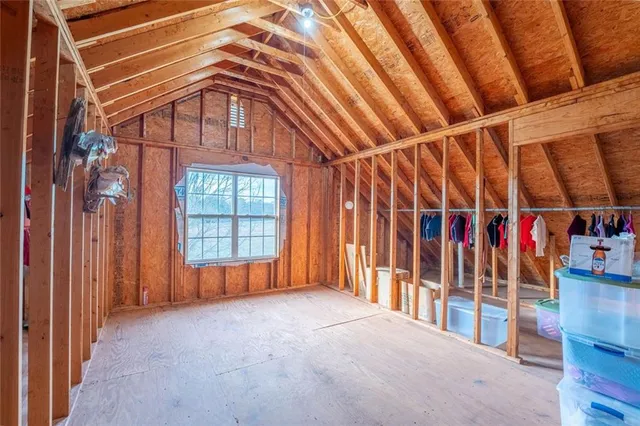 a living room with furniture gym equipment and a chandelier