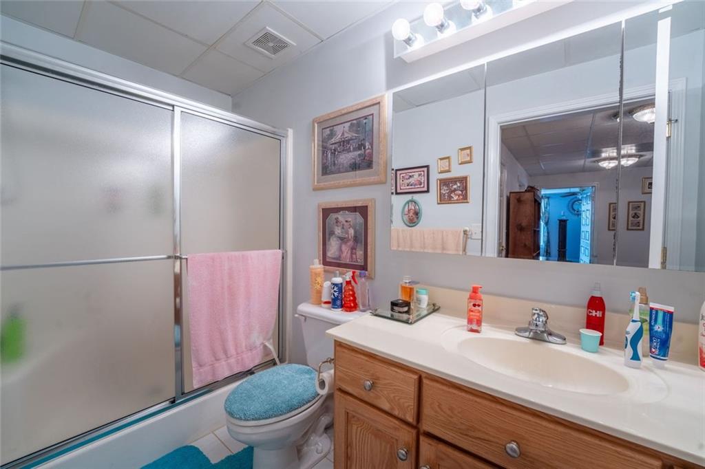 2440 Deadwyler Road Maysville, GA 30558 - Photo 31 of 79 a bathroom with a sink vanity mirror and toilet