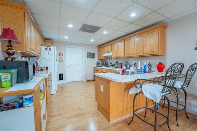 a view of a large house with a yard and large trees