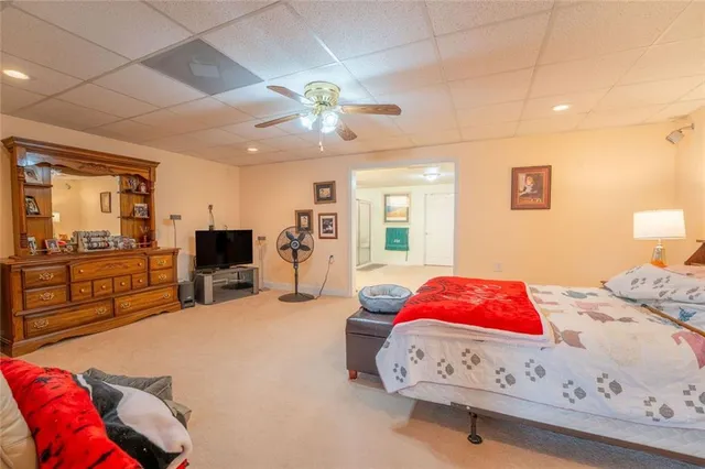 a view of a house with a yard and a large tree