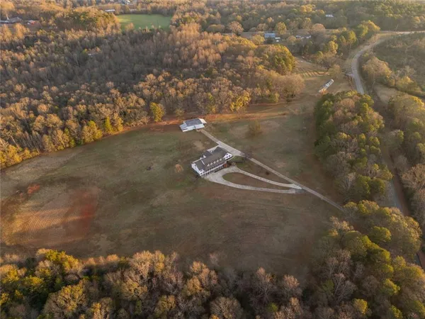 an aerial view of house with yard and mountain view in back
