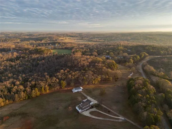 an aerial view of house with yard and mountain view in back