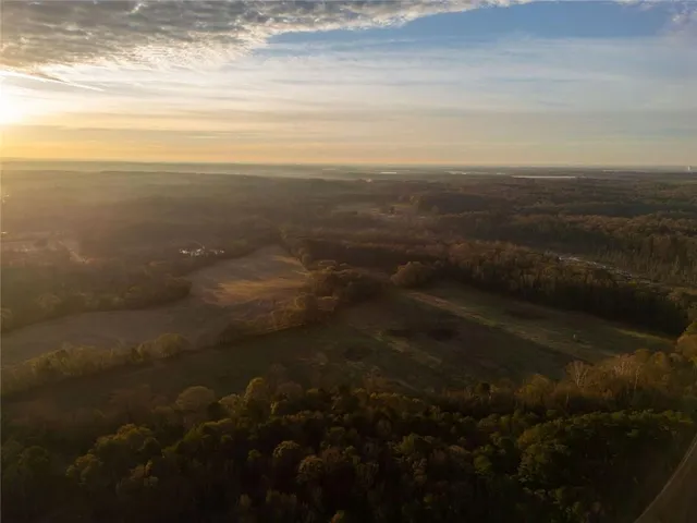 a view of a house with a yard next to a lake
