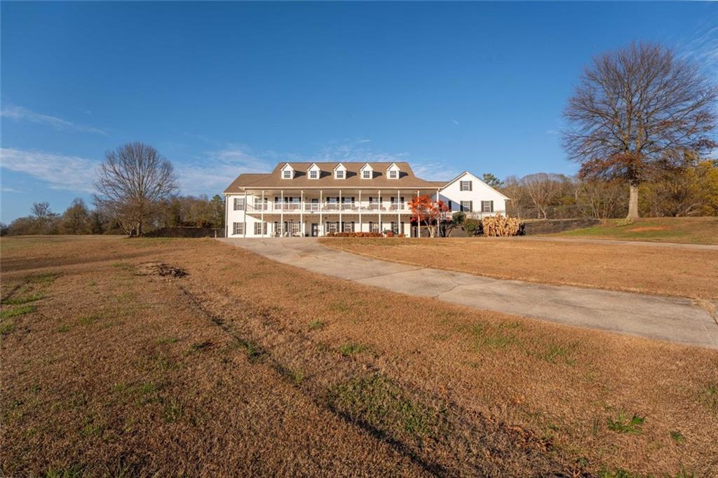 2440 Deadwyler Road Maysville, GA 30558 - Photo 58 of 79 a view of a large house with a yard and large trees