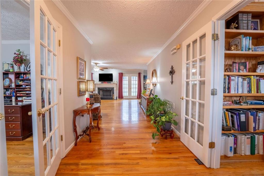 2440 Deadwyler Road Maysville, GA 30558 - Photo 6 of 79 a hallway with wooden floor a book shelf and a book shelf