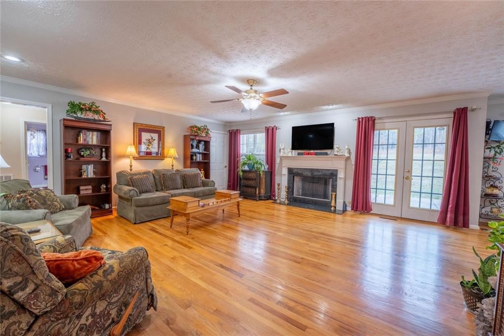 2440 Deadwyler Road Maysville, GA 30558 - Photo 7 of 79 a living room with furniture a flat screen tv and a fireplace