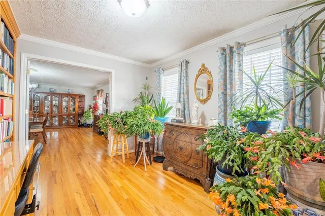 a view of a dining room with furniture a chandelier and wooden floor
