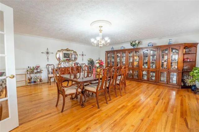 a dining room with furniture entryway and wooden floor