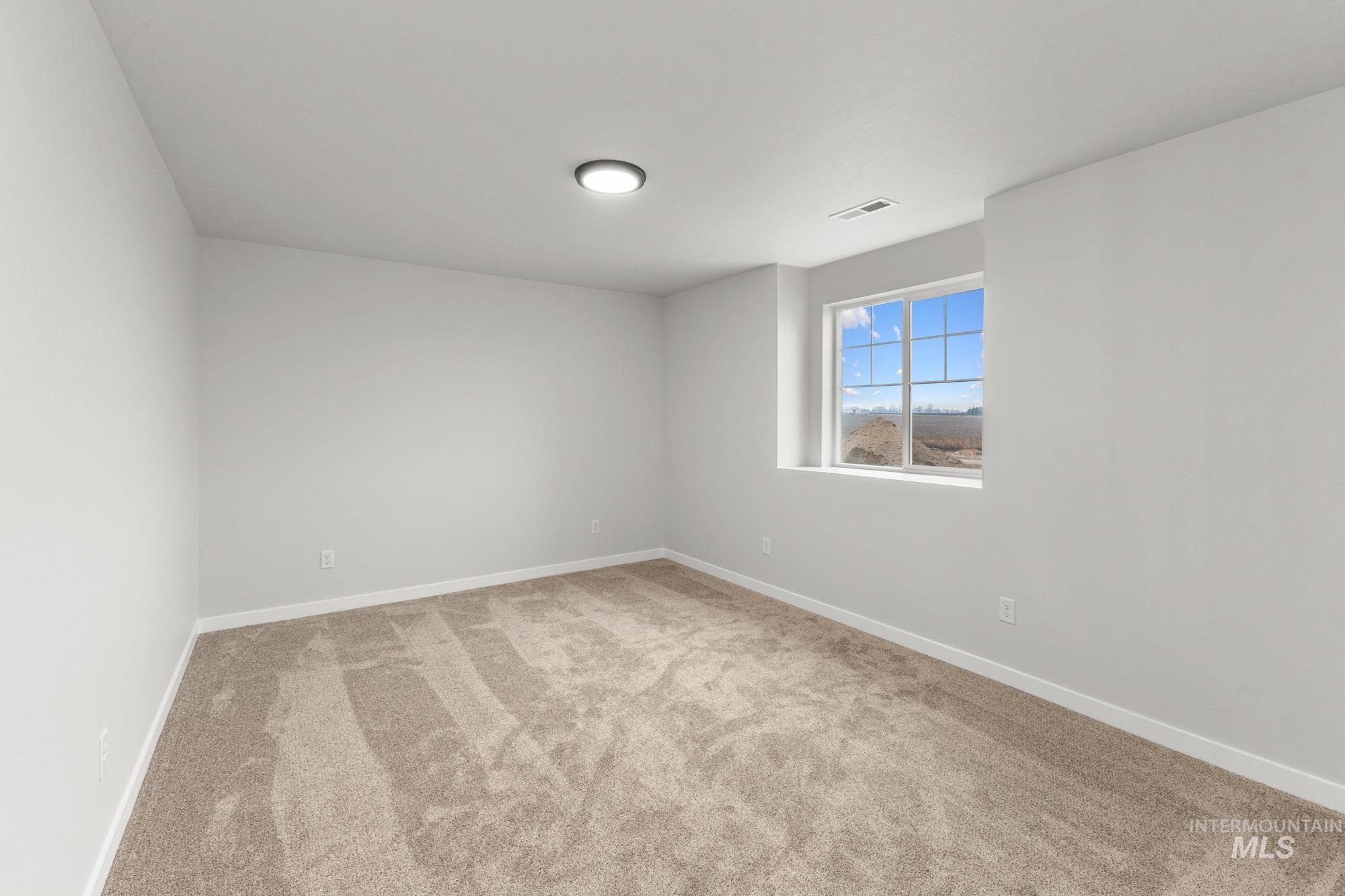 3762 West Maypearl Street Meridian, ID 83642 - Photo 15 of 29 Unfurnished room featuring light carpet and baseboards