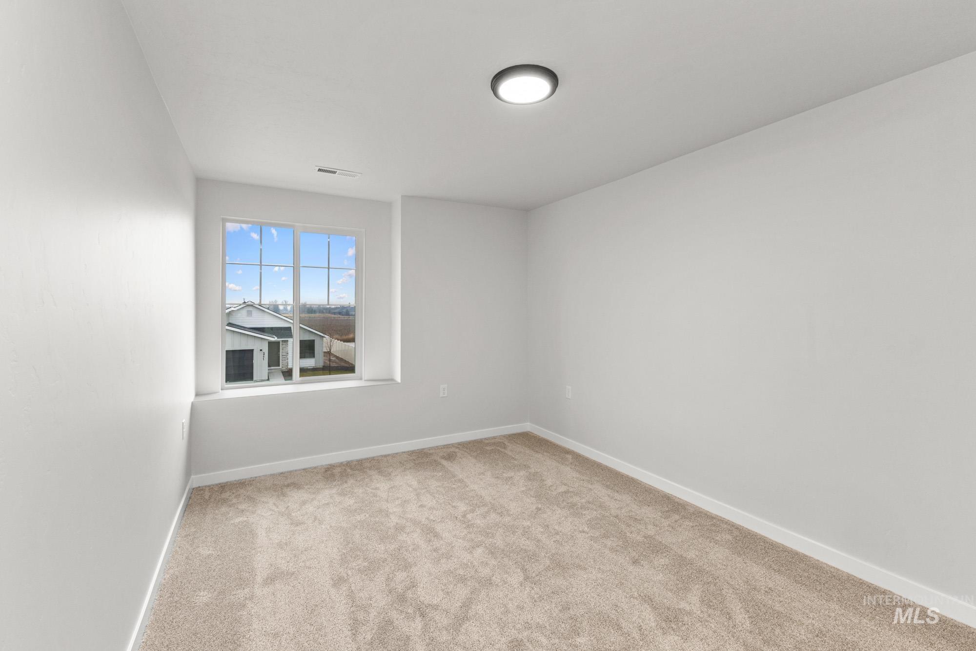 3762 West Maypearl Street Meridian, ID 83642 - Photo 17 of 29 Spare room with light carpet and baseboards