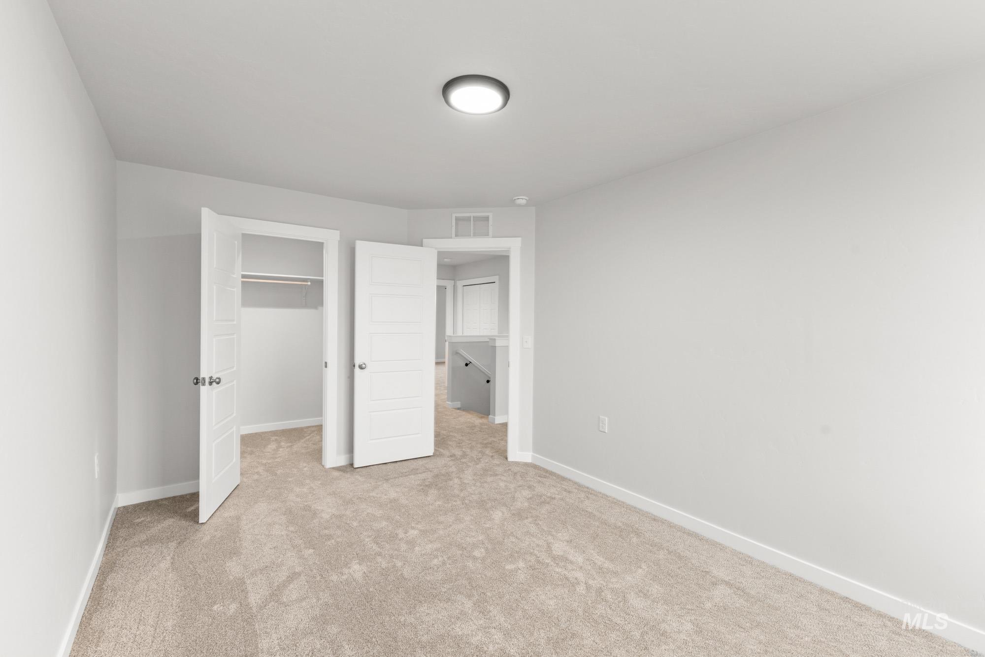 3762 West Maypearl Street Meridian, ID 83642 - Photo 18 of 29 Unfurnished bedroom featuring a spacious closet and light colored carpet