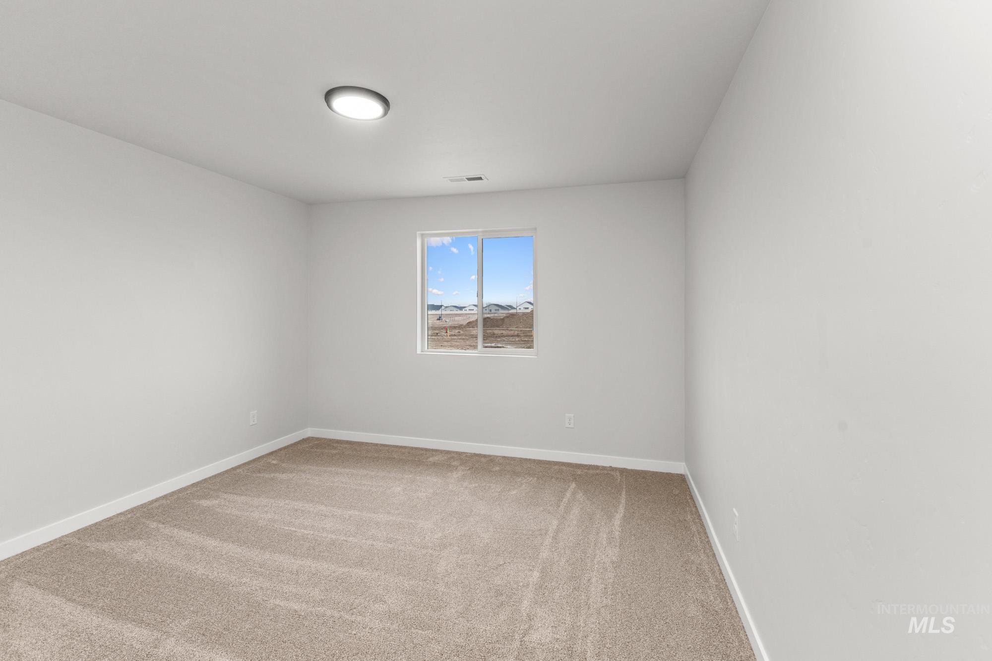 3762 West Maypearl Street Meridian, ID 83642 - Photo 19 of 29 Empty room with light carpet and baseboards
