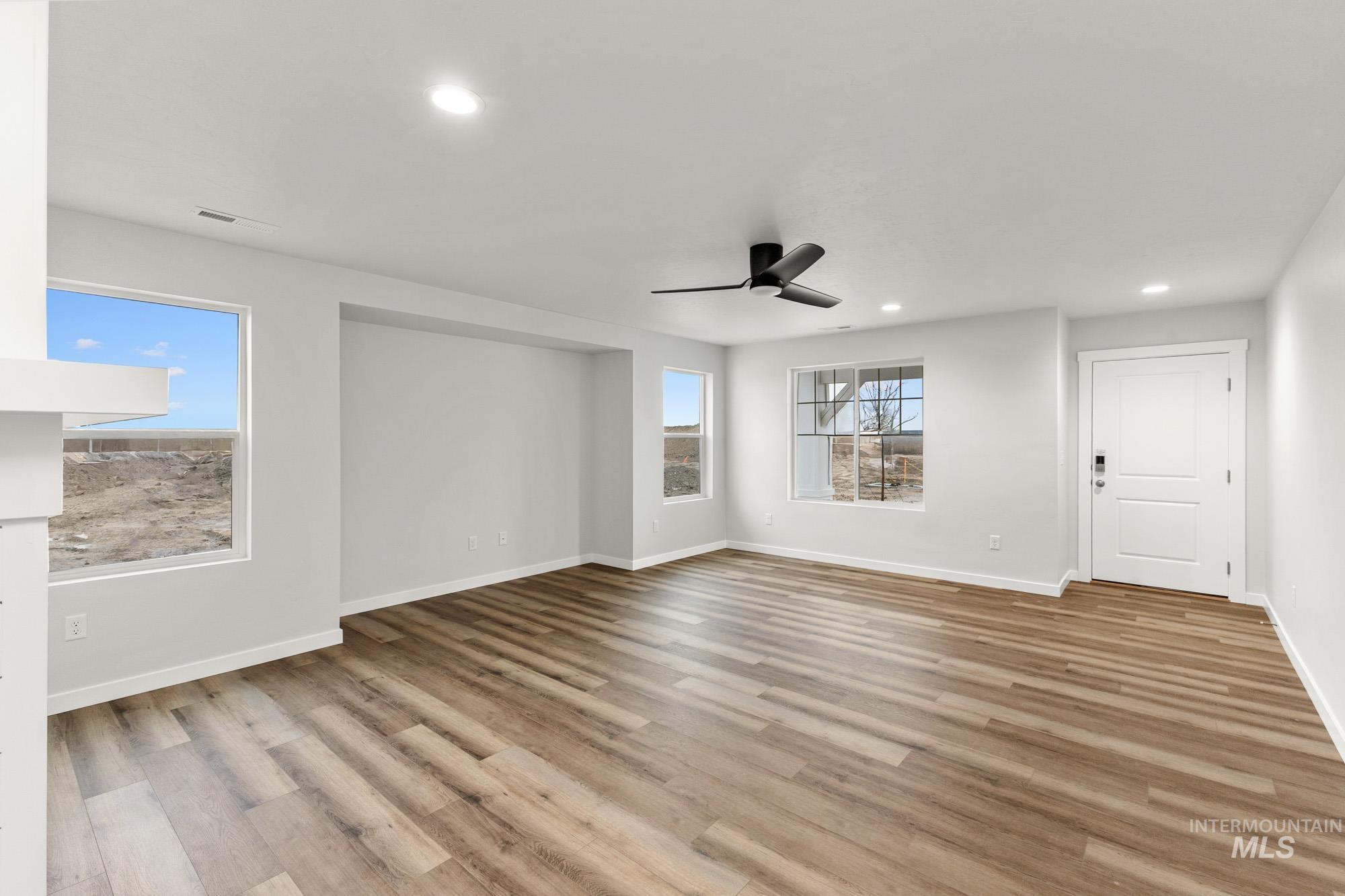 3762 West Maypearl Street Meridian, ID 83642 - Photo 2 of 29 Empty room featuring light wood-style flooring, recessed lighting, and ceiling fan