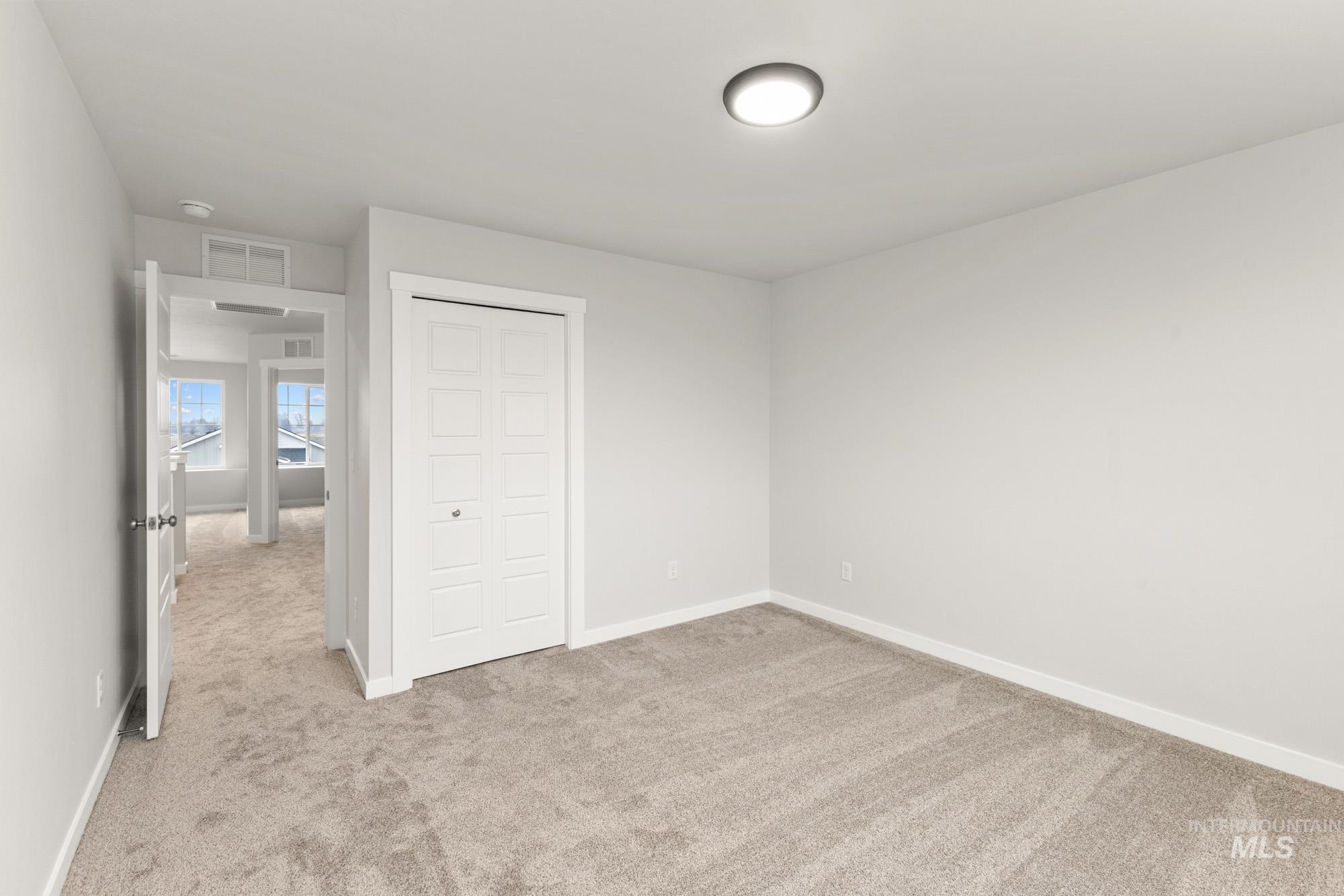 3762 West Maypearl Street Meridian, ID 83642 - Photo 20 of 29 Unfurnished bedroom with light colored carpet and a closet