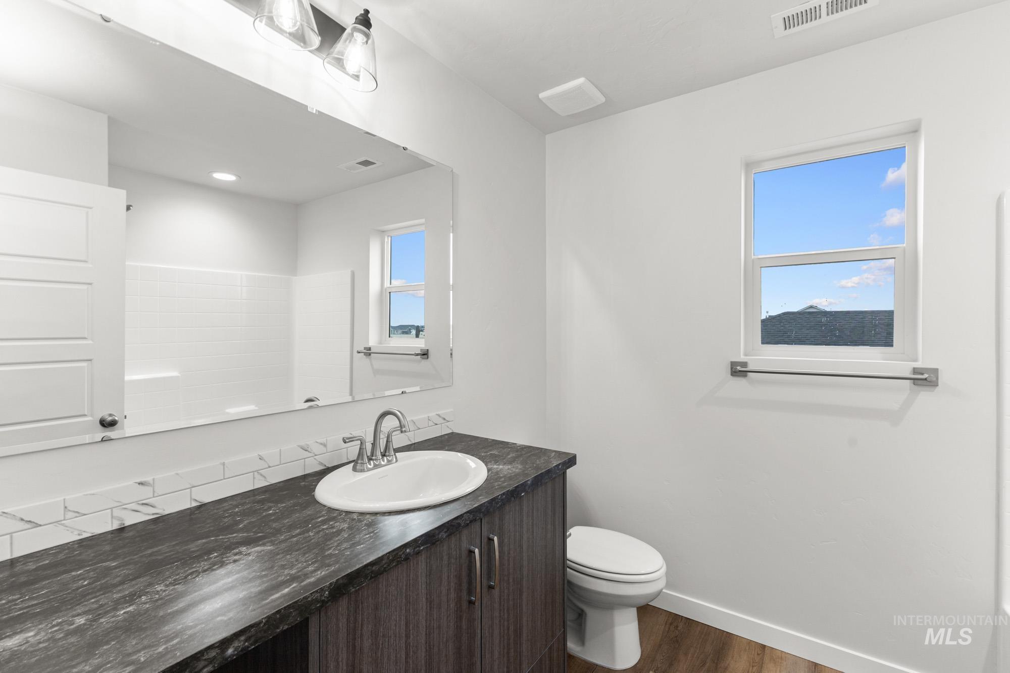 3762 West Maypearl Street Meridian, ID 83642 - Photo 21 of 29 Bathroom featuring vanity and dark wood-style flooring