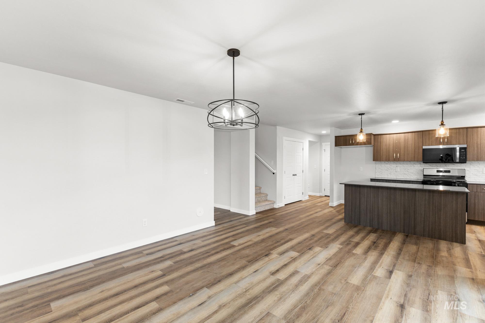 3762 West Maypearl Street Meridian, ID 83642 - Photo 29 of 29 Kitchen with open floor plan, a center island, a chandelier, and decorative light fixtures