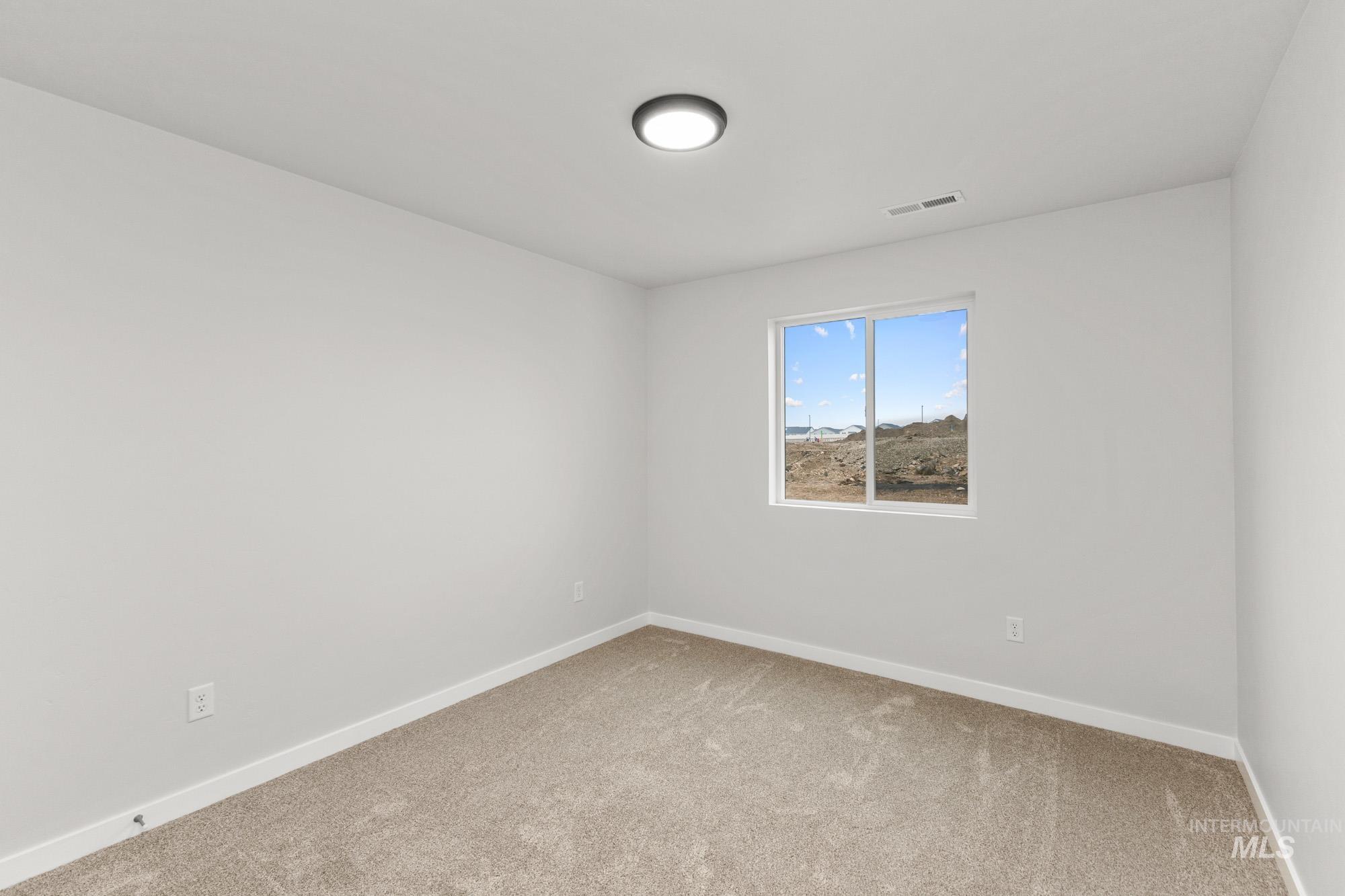 3762 West Maypearl Street Meridian, ID 83642 - Photo 9 of 29 Spare room featuring light colored carpet and baseboards