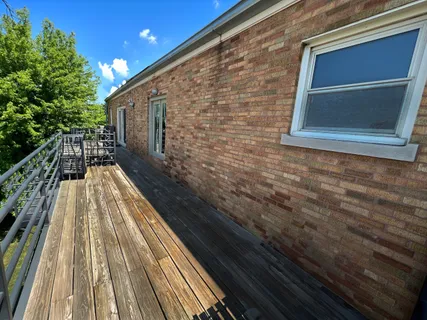 a view of balcony with wooden floor