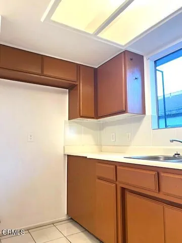 a kitchen with a sink and a refrigerator