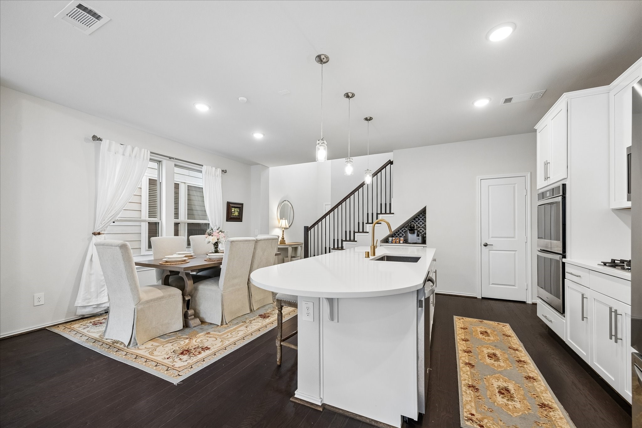4026 Delta Rose Street Houston, TX 77018 - Photo 12 of 44 Bright kitchen and dining area with large island, pendant lighting and stainless appliances. Offers easy connection between prep, dining and everyday living spaces.