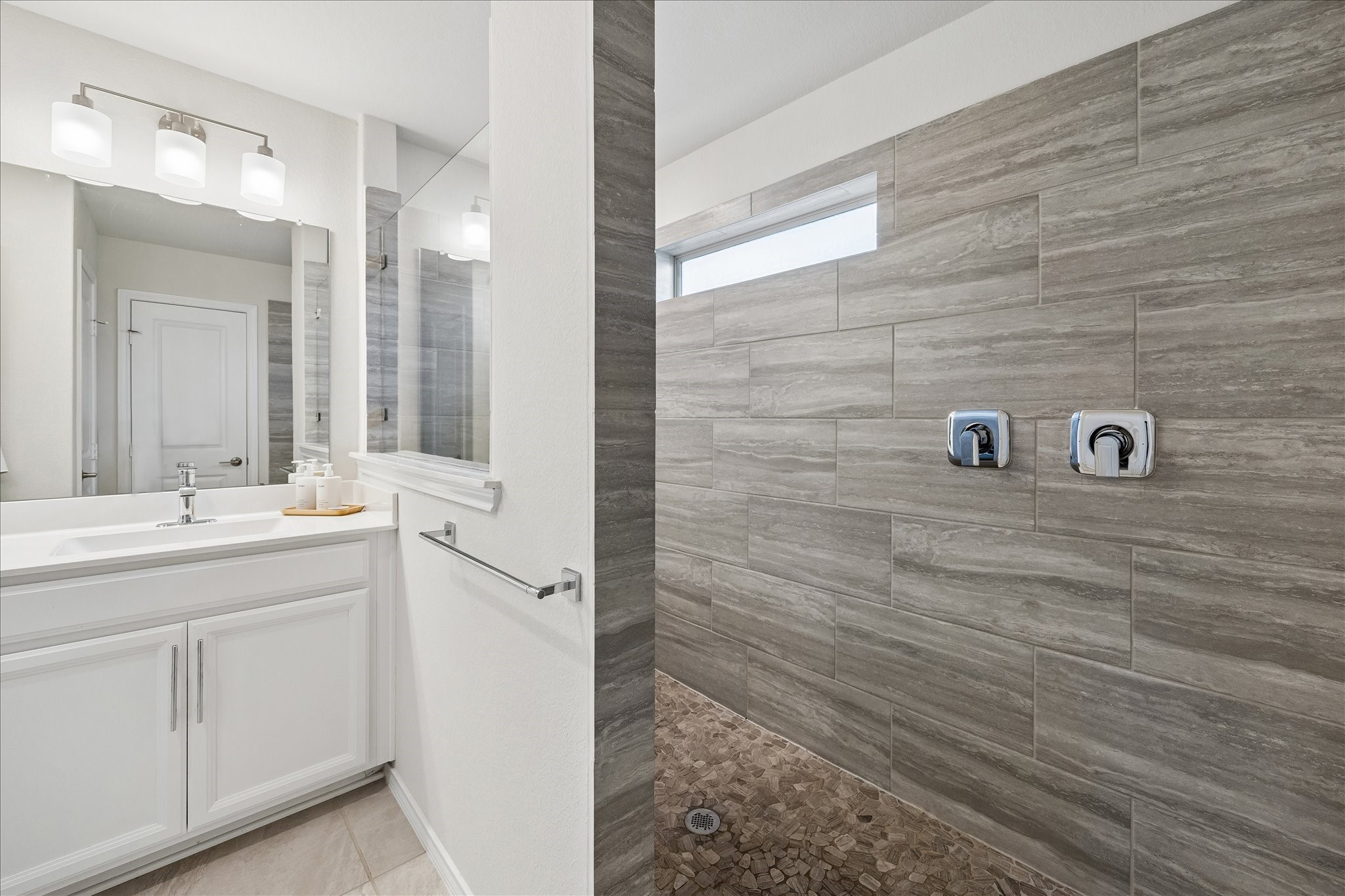 4026 Delta Rose Street Houston, TX 77018 - Photo 18 of 44 Primary en suite with walk in shower with floor to ceiling tile and modern fixtures.