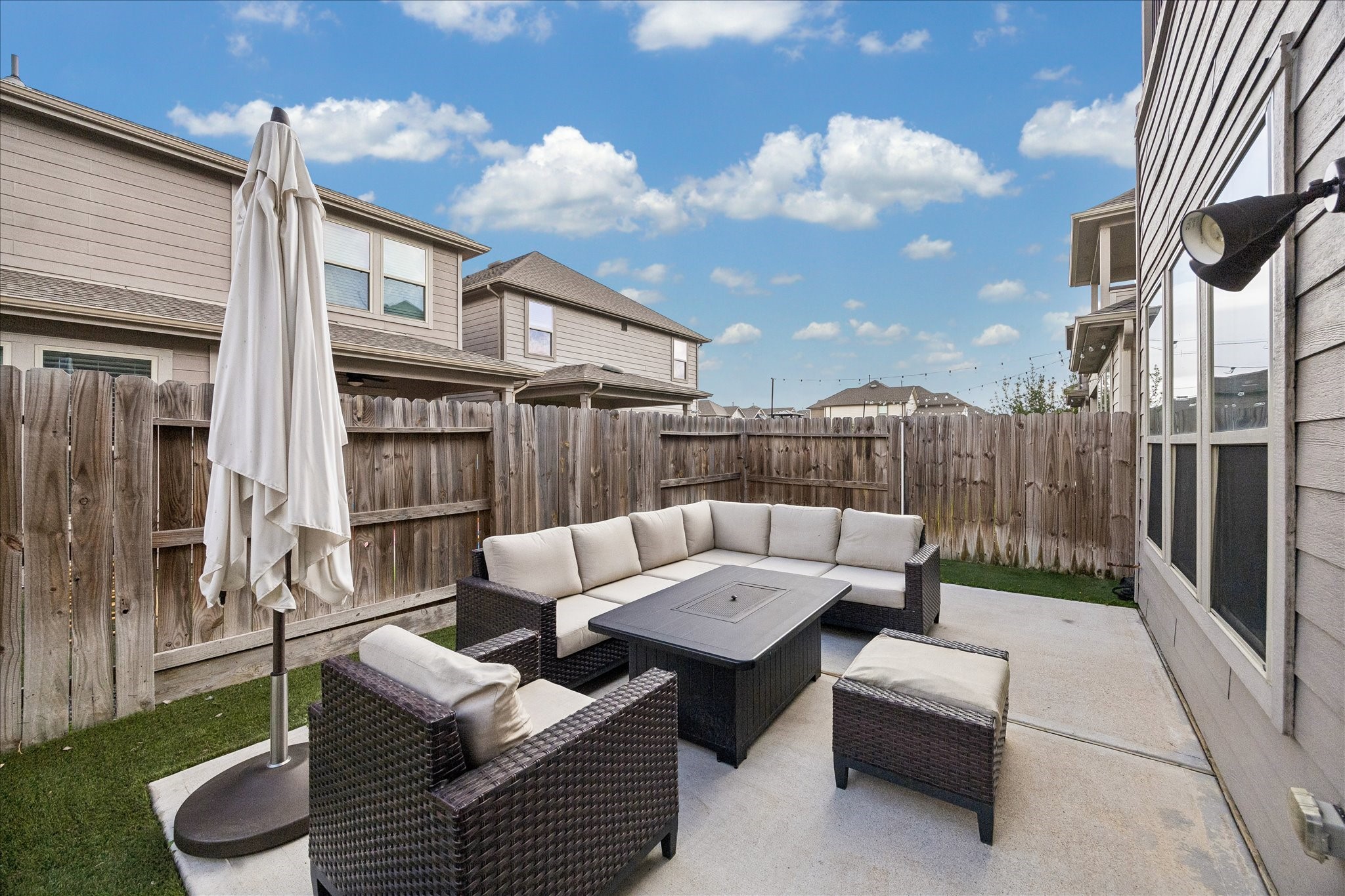4026 Delta Rose Street Houston, TX 77018 - Photo 31 of 44 Backyard patio with dedicated seating area and fenced yard offering a comfortable space for outdoor entertaining and relaxation.