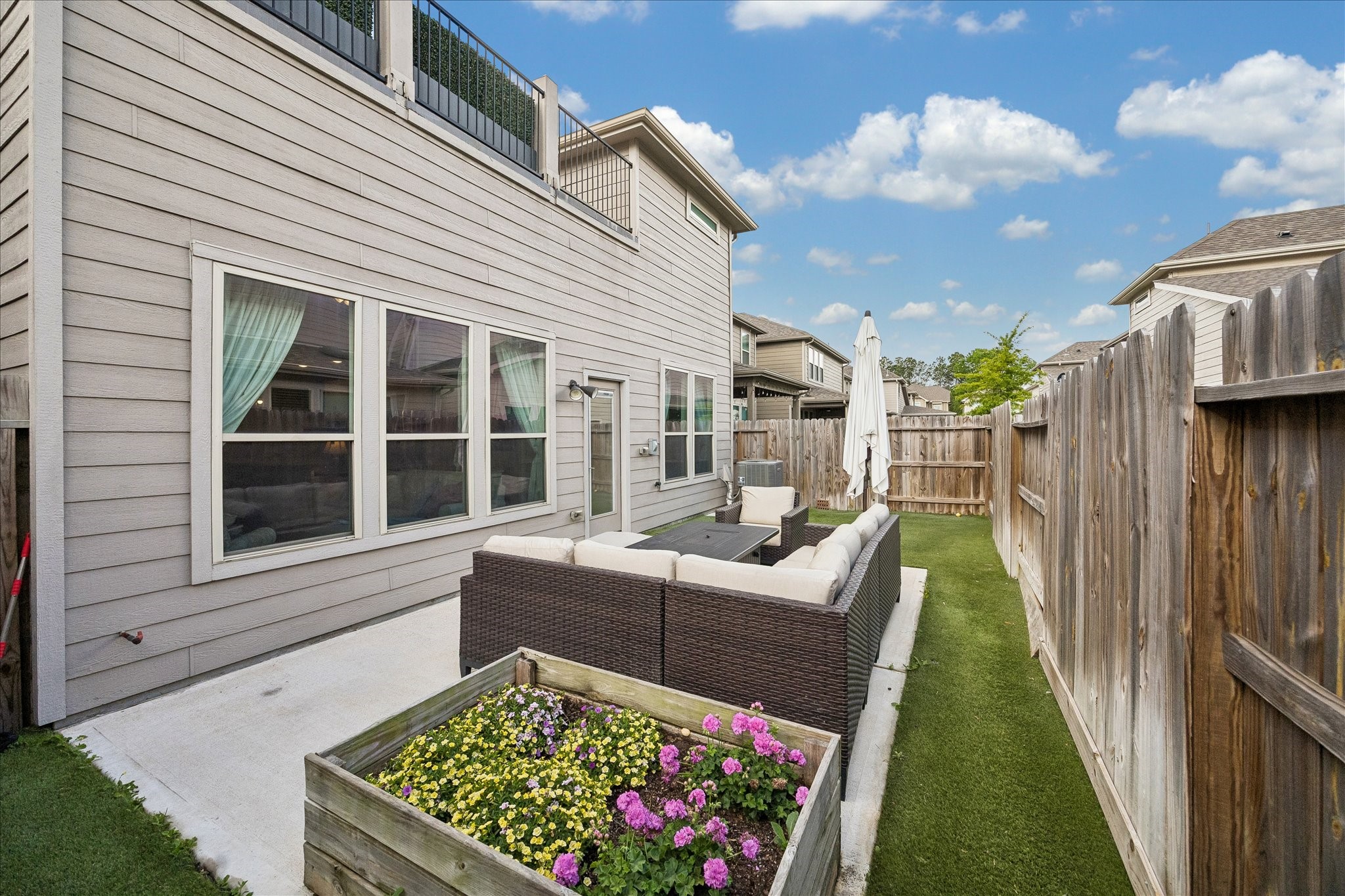 4026 Delta Rose Street Houston, TX 77018 - Photo 33 of 44 Backyard patio seating, green space and raised planter offering functional outdoor area.