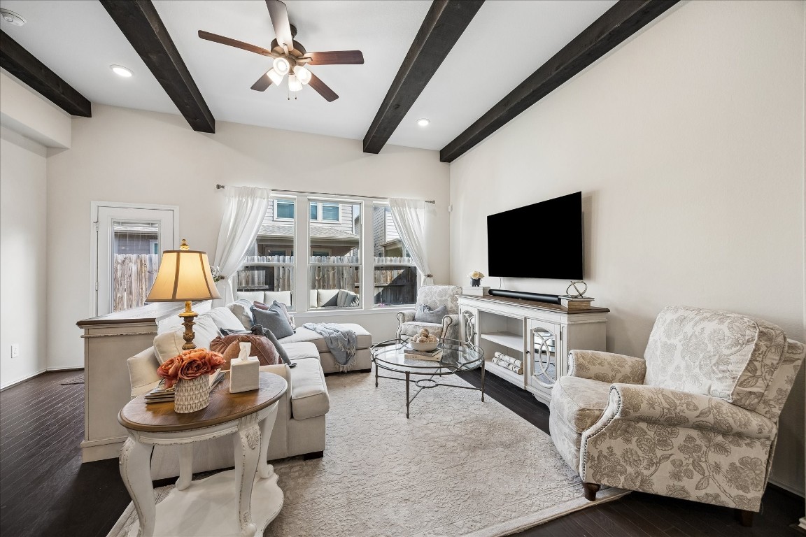 4026 Delta Rose Street Houston, TX 77018 - Photo 8 of 44 Light filled living room with wood beam accents, and large windows overlooking the backyard.