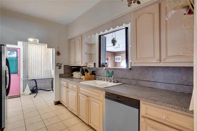 a kitchen with a sink cabinets and utility