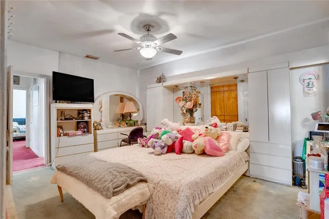 a bedroom with a bed and flat tv