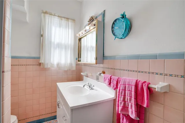 a bathroom with a sink mirror and a bathtub