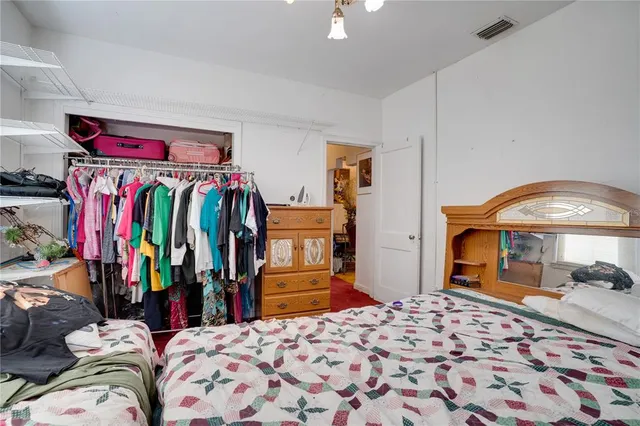 a bedroom with a bed and a closet