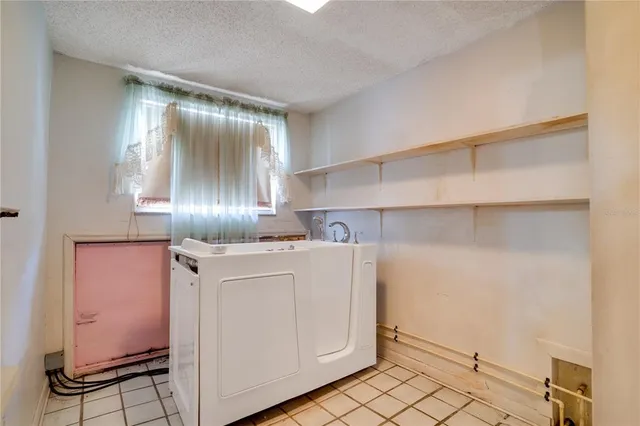 a utility room with cabinets washer and dryer