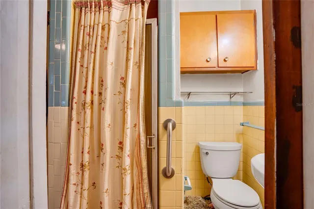 a bathroom with a toilet a sink and a window