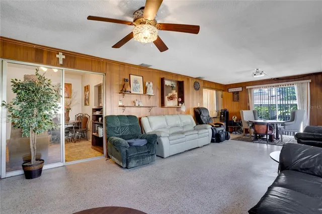 a living room with furniture gym equipment and a large window
