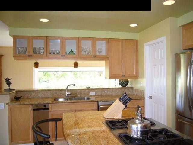 347 Holopuni Road Kula, HI 96790 - Photo 8 of 22 a living room with kitchen island granite countertop furniture and a fireplace