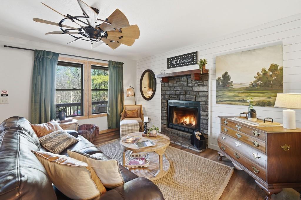589 Spalding Circle Ellijay, GA 30540 - Photo 11 of 68 a living room with furniture a fireplace and a large window