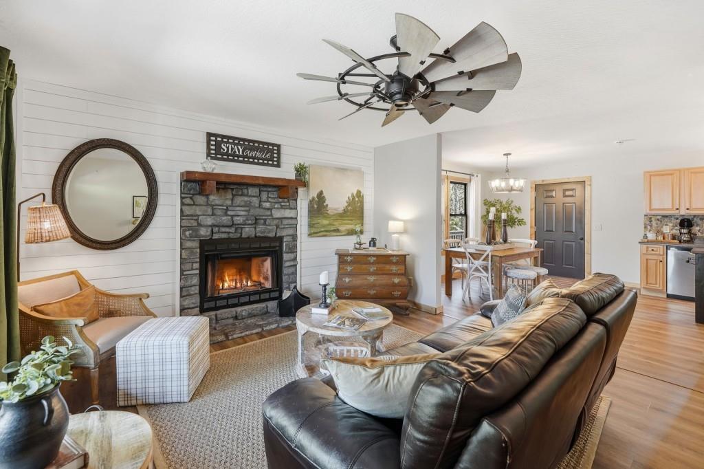 589 Spalding Circle Ellijay, GA 30540 - Photo 13 of 68 a living room with furniture a chandelier and a fireplace