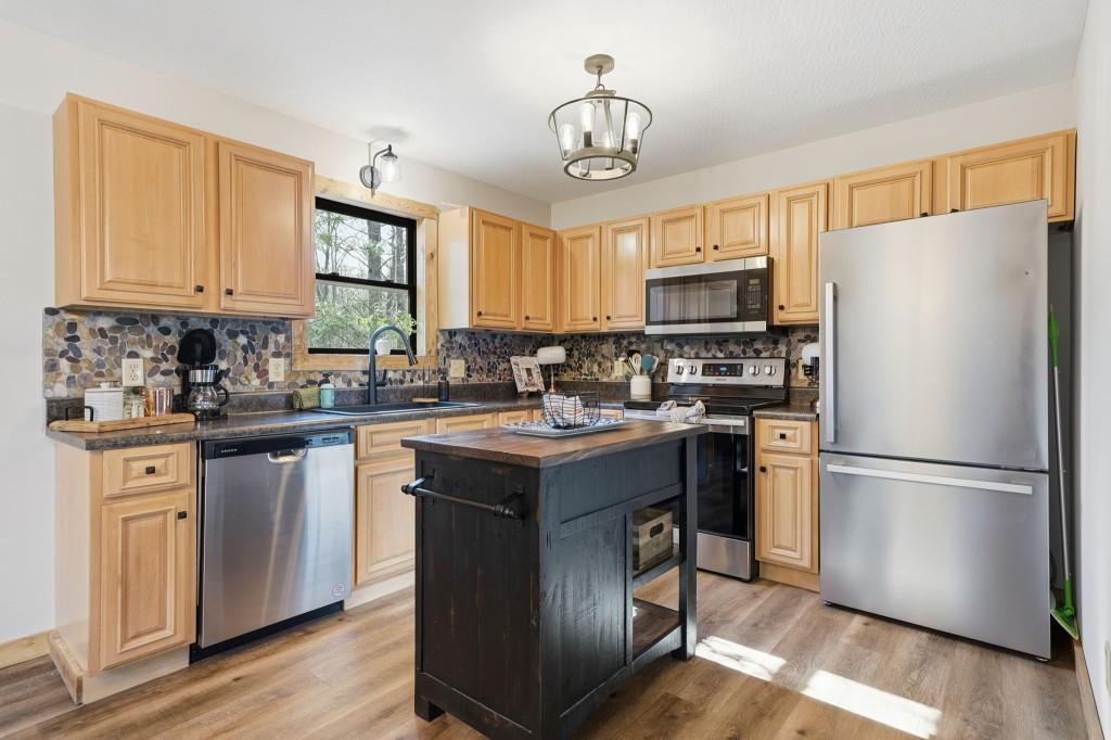 589 Spalding Circle Ellijay, GA 30540 - Photo 6 of 68 a kitchen with kitchen island granite countertop a sink stove and refrigerator