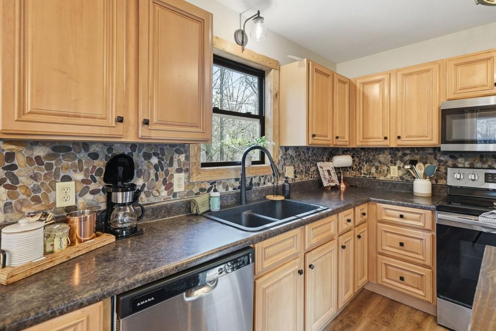 589 Spalding Circle Ellijay, GA 30540 - Photo 7 of 68 a kitchen with stainless steel appliances granite countertop a sink a stove and cabinets