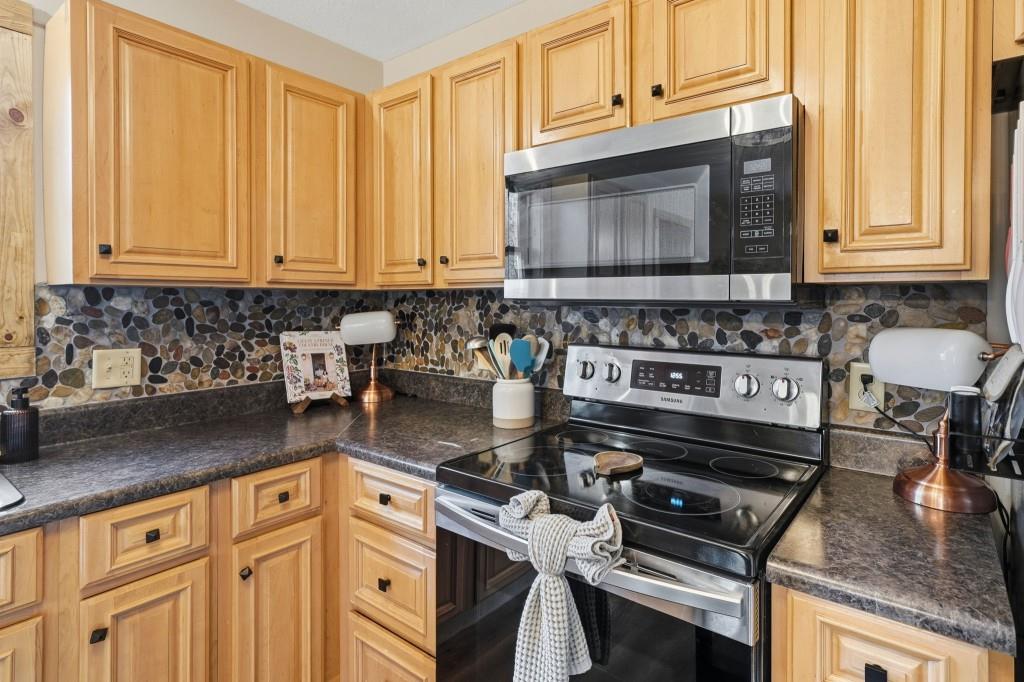 589 Spalding Circle Ellijay, GA 30540 - Photo 8 of 68 a kitchen with stainless steel appliances granite countertop a stove a sink and a microwave