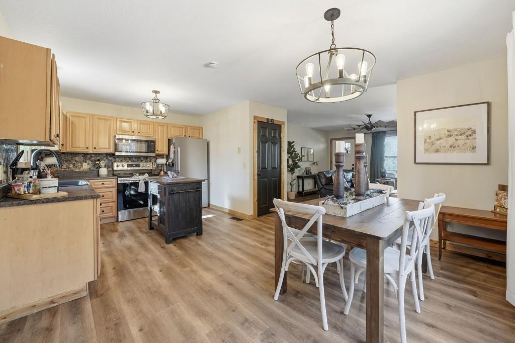 589 Spalding Circle Ellijay, GA 30540 - Photo 9 of 68 a view of a dining room with furniture a chandelier and wooden floor