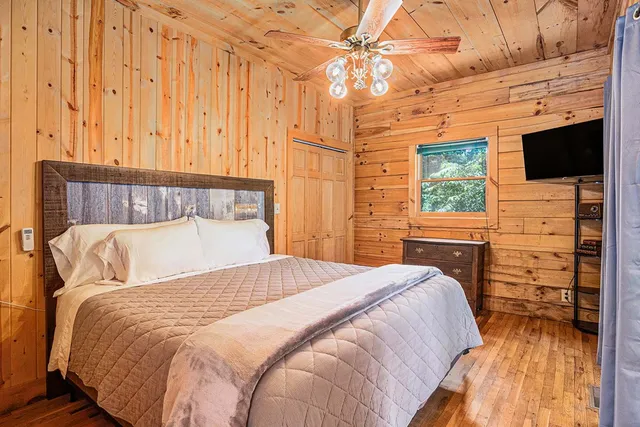 a bed sitting in a bedroom next to a window