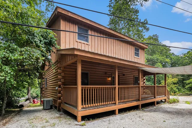 a view of a house with a yard next to a road